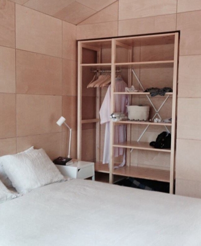Solid wood Lundia shelving in a bedroom
