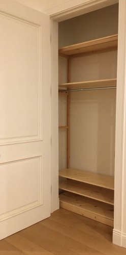 Solid wood Lundia shelving in a bedroom