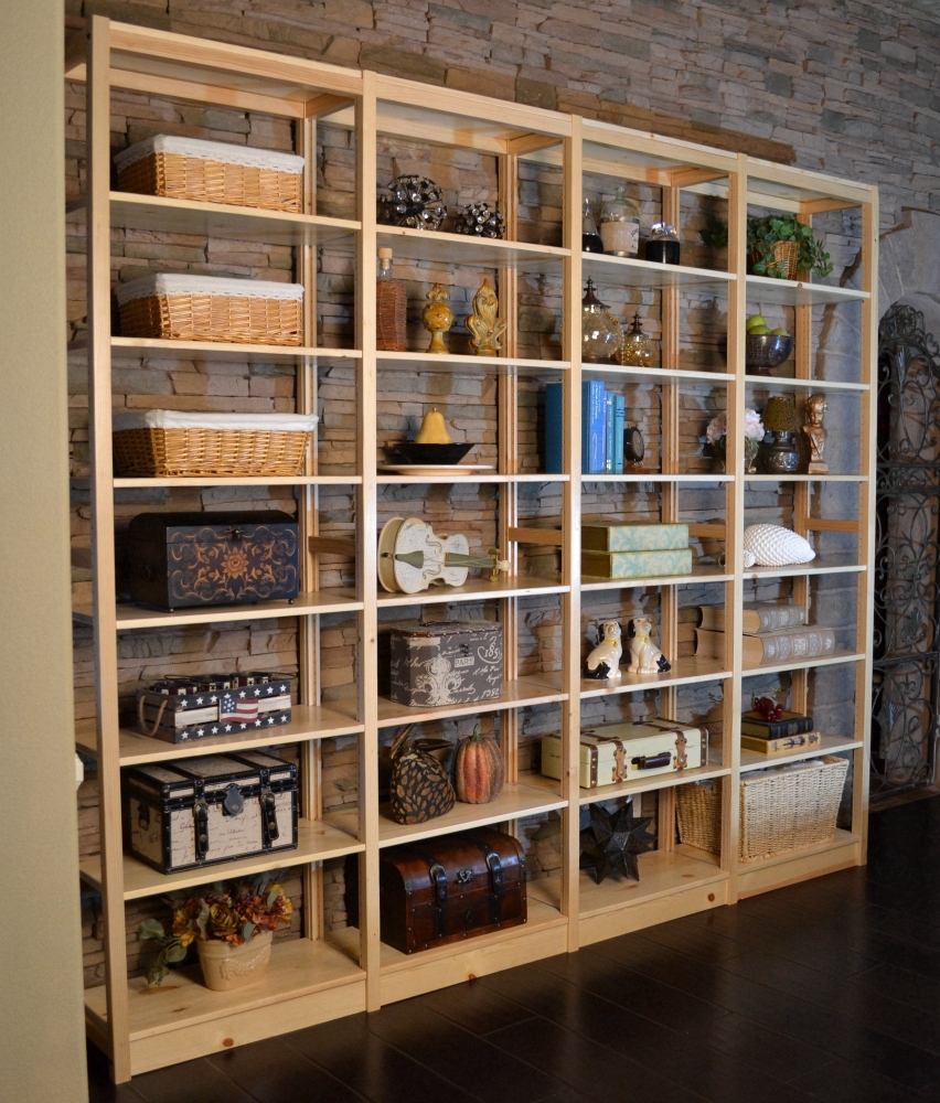 Pine bookcase against a stone wall