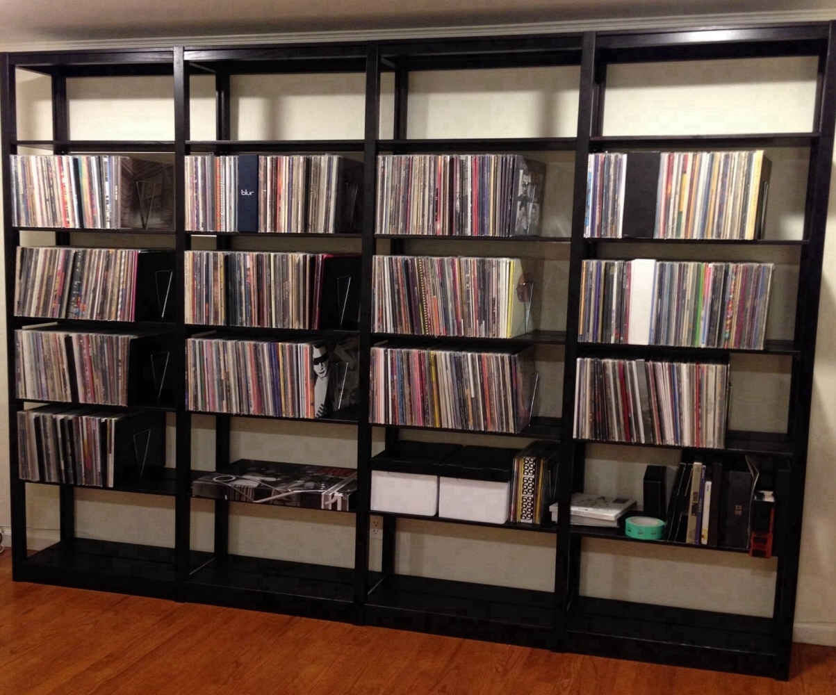 Black solid wood bookcase wall full of vinyl records