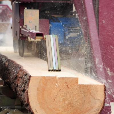 A sawmill blade cutting a log into boards