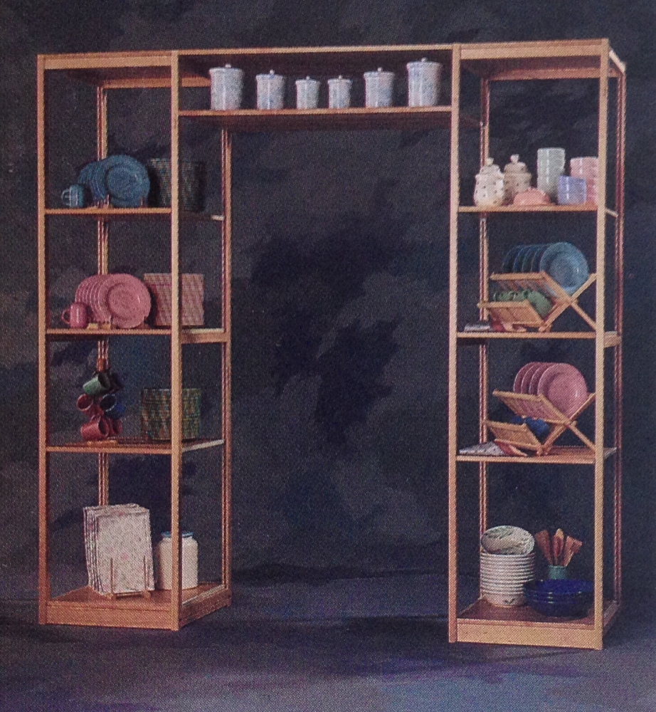 Pine shelving arranged as decorative archway with ceramics and dinnerware