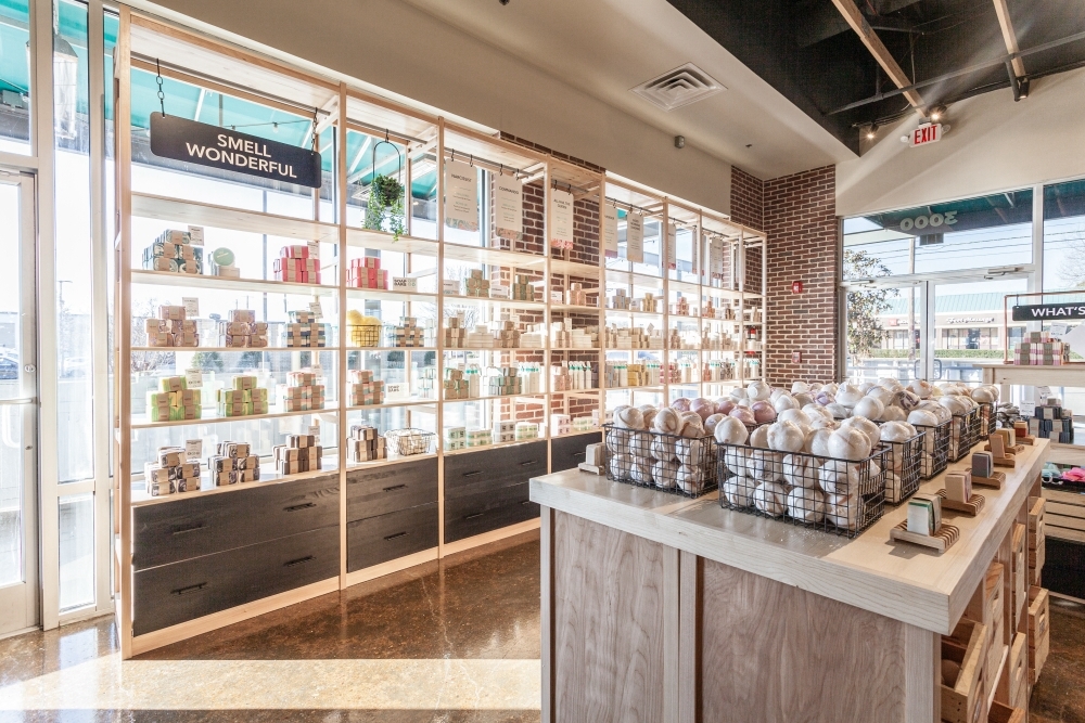 Pine retail shelving with drawers displaying soap and personal care products