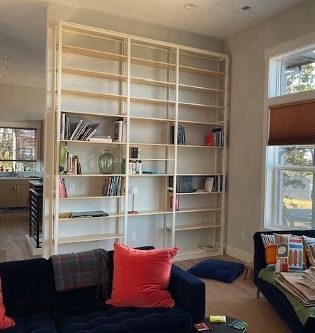 Floor-to-ceiling solid wood wall shelving by Lundia USA